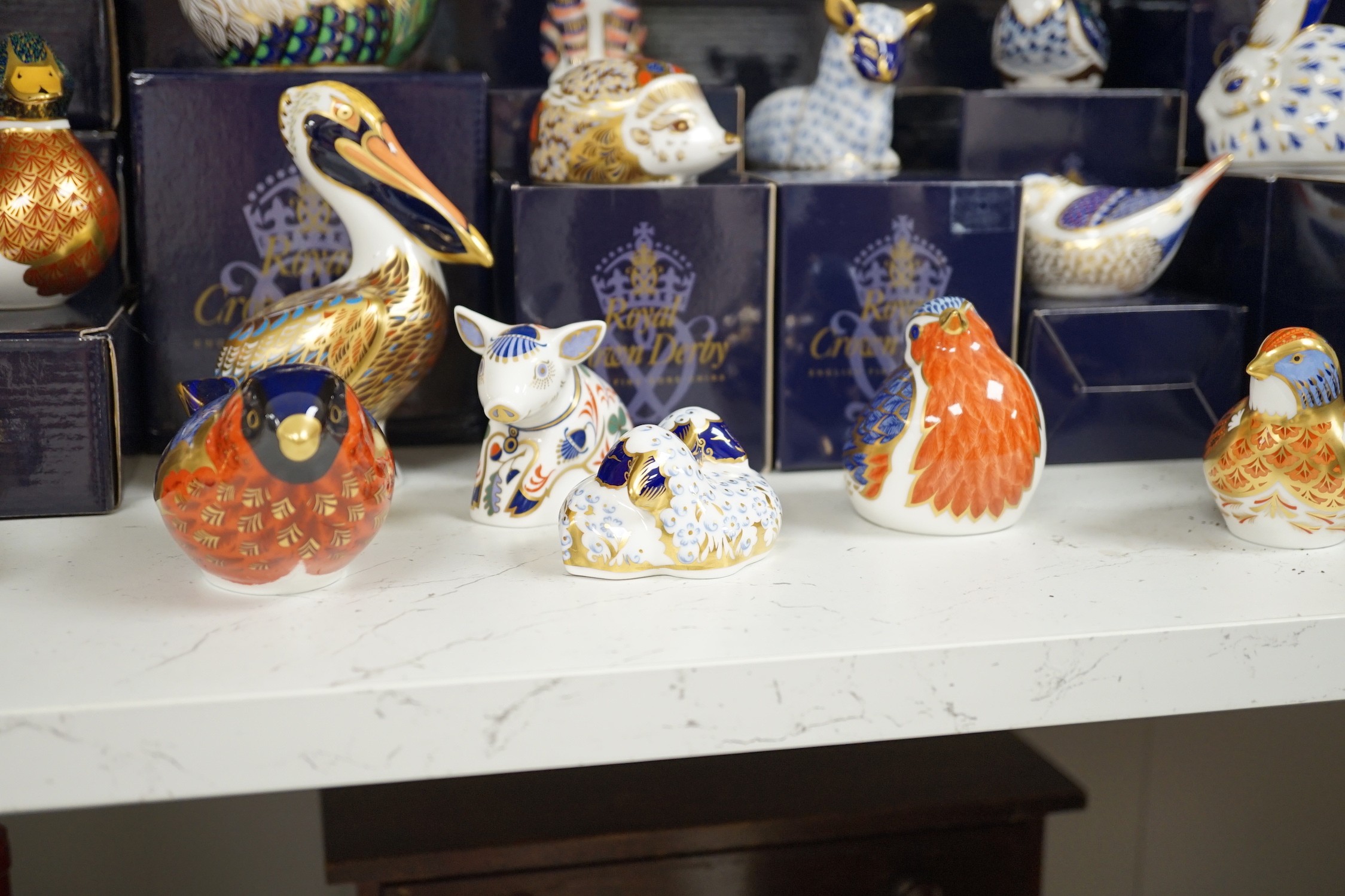 Approximately thirty-two Royal Crown Derby Imari porcelain paperweights, all but two with original boxes and mostly gold bottoms
